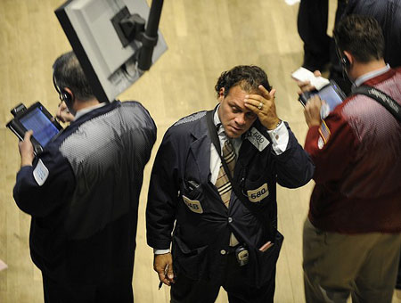 A trader on the floor of the New York Stock Exchange holds his head as he walks off the floor September 29, 2008 as the Dow closes over 600 points after the House rejected a $700 billion financial bailout plan. 